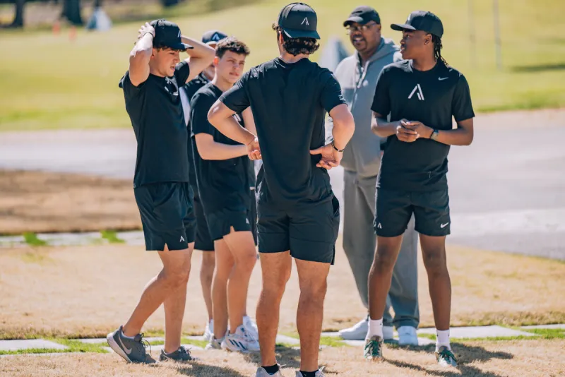 Coaches and athletes on field